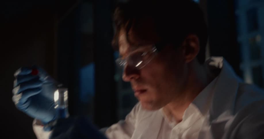A man working in a lab with liquid