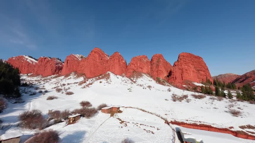 An aerial view of some mountains covered in snow