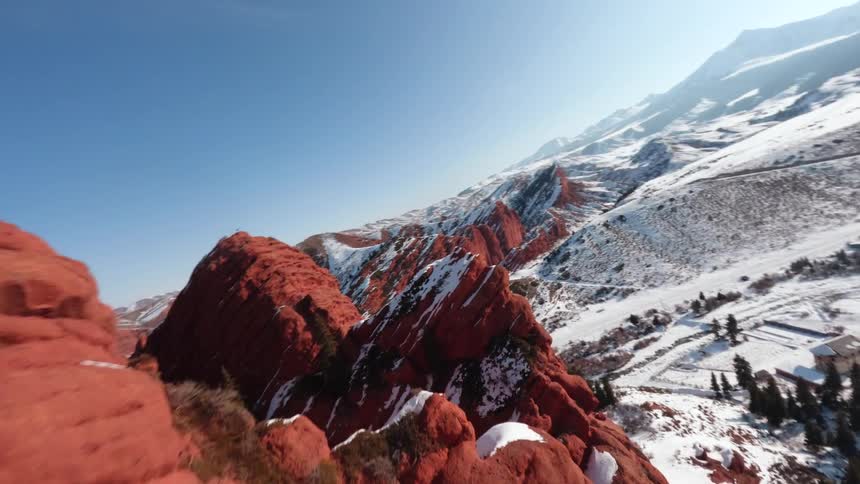 An aerial view of a mountain covered in snow