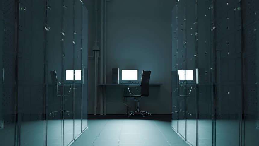 A camera moves back through a dark server room filled with rows of glass cabinets to reveal two workstations with glowing computer screens and black chairs
