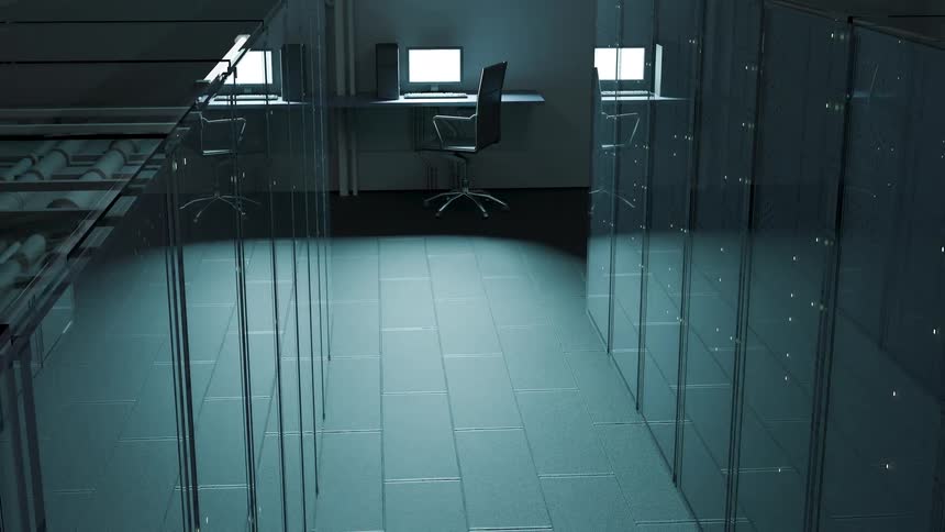 Chair at a table with a computer and monitor at the end of a data center server room