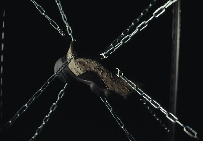 An item being held up by chains with strobe lights on it