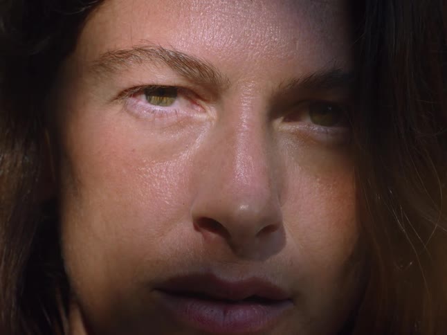 Woman with a serious expression illuminated by natural light