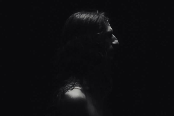 Lightning flashes illuminating a long haired native american man in the darkness