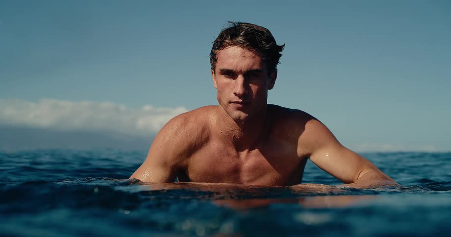 A man swimming in water on a sunny day