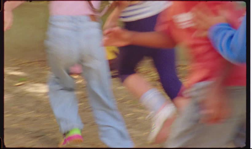 A group of kids running around outdoors playing