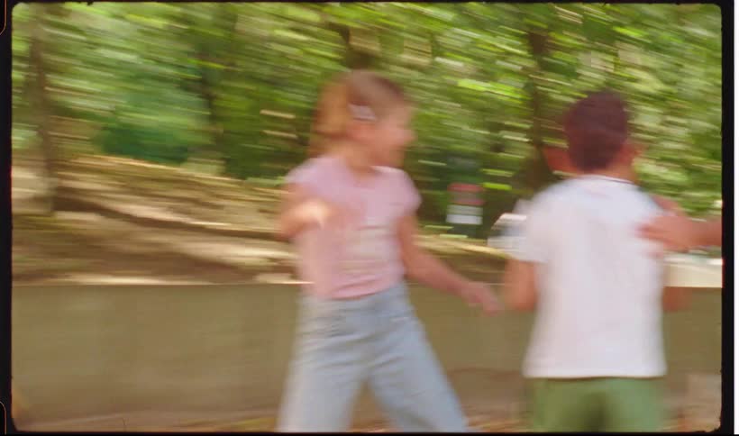 Children running and playing in a park with trees
