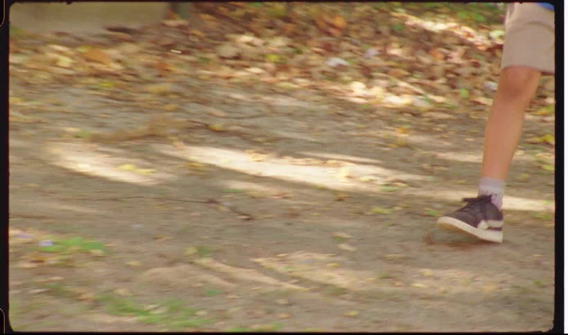 Childrens feet running and walking on dirt ground in a park