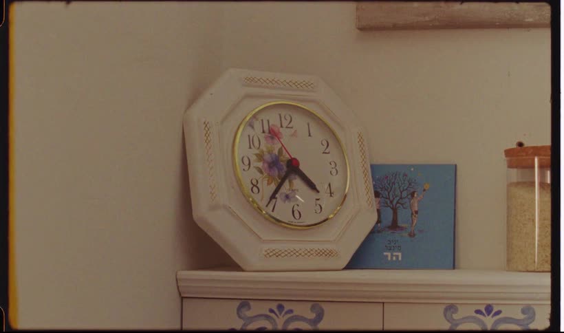 A clock sitting on a mantel in a room