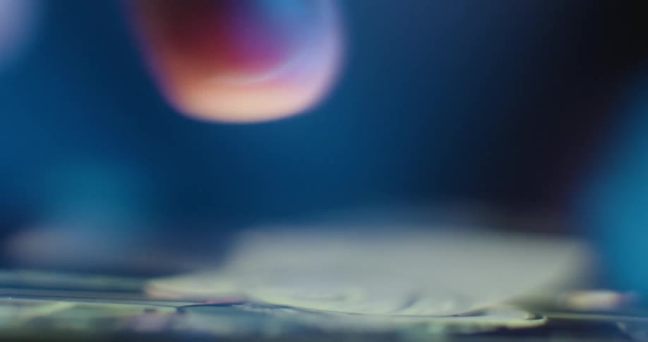 An extreme closeup of a persons finger as it interacts with a glowing touchscreen interface the bluetoned lighting and shallow depth of field emphasize the tactile connection between the user and the digital device