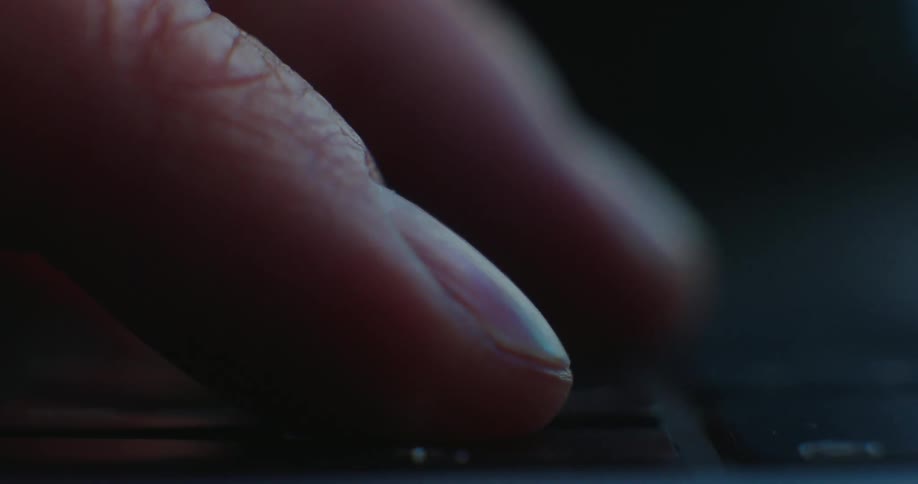 Finger pressing a key on an electronic device