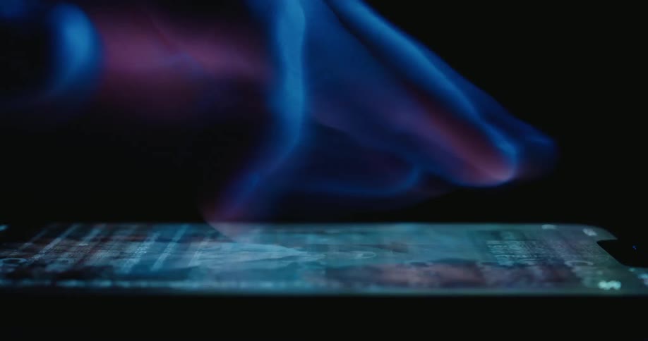 A hand is scrolling very quickly on a smartphone against a black background