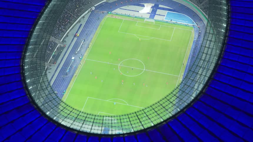 Aerial of soccer teams playing a game in a sports stadium