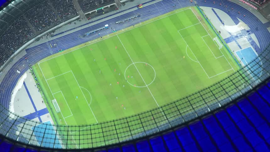Audience fills the stadium during a nighttime soccer game