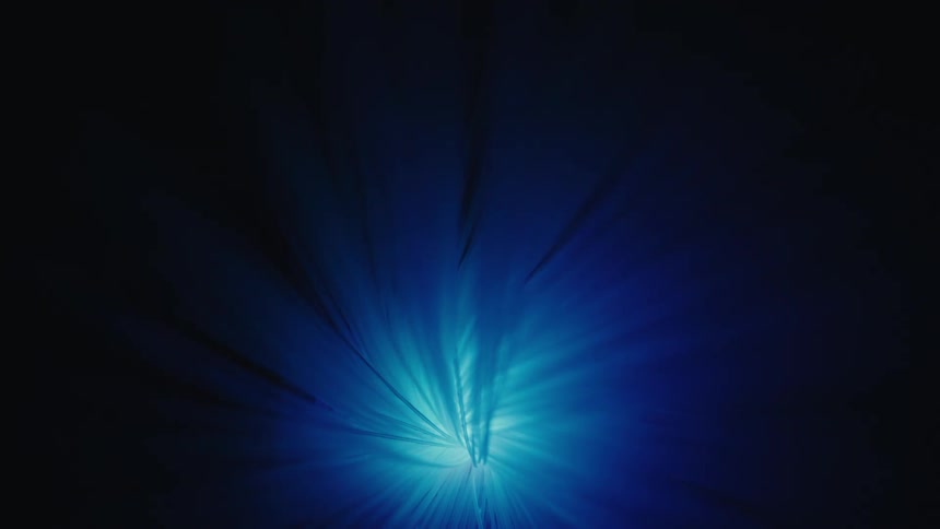 Light beams radiating in a radial pattern on a dark background