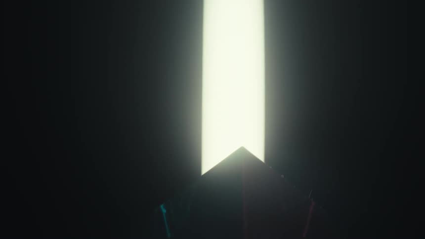 Colored light reflections passing through a prismatic glass surface in a dark environment