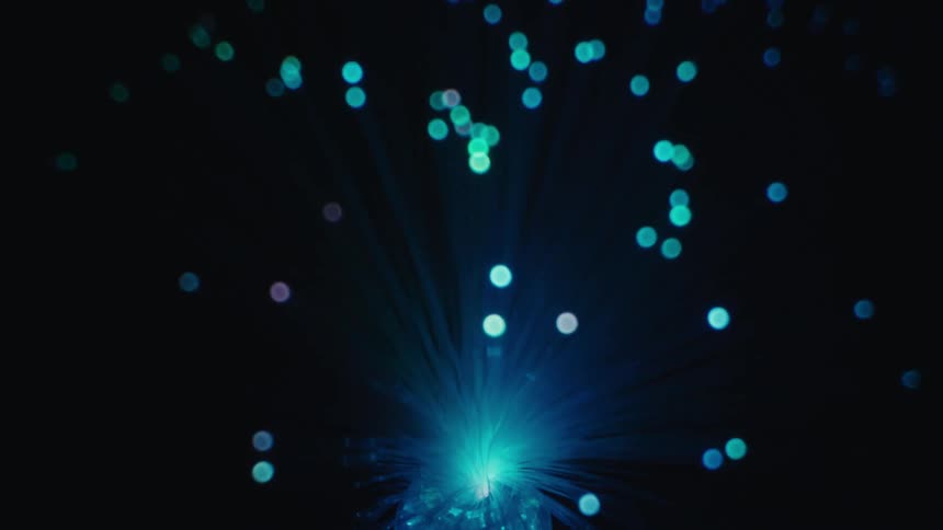 A disco ball reflecting colorful lights in a dark environment