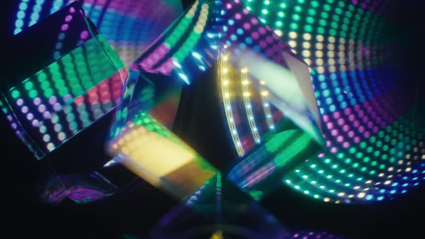Reflective cubes with colorful light patterns in a dark environment