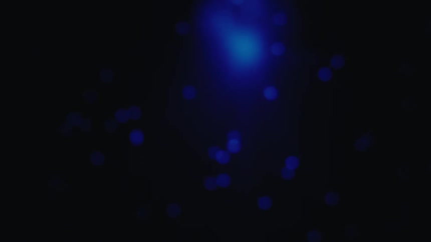 A starry sky at night with green lights floating across the dark sky