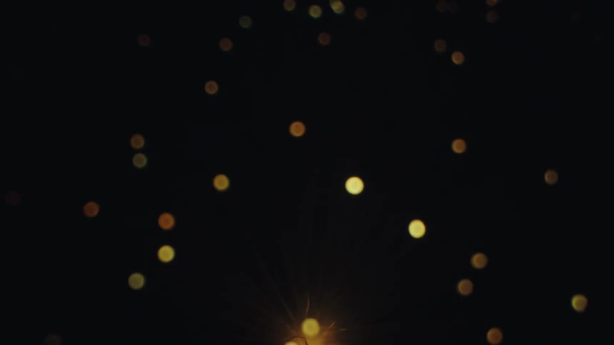 A fiber optic lamp emits changing colored light points against a dark background