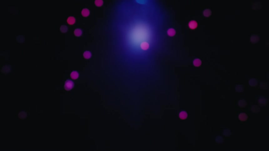 Disco lights of various colors illuminating a dark atmosphere