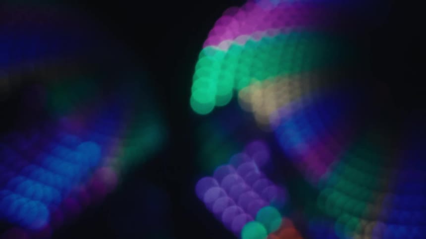 Outoffocus colorful light dots forming abstract patterns on a dark background