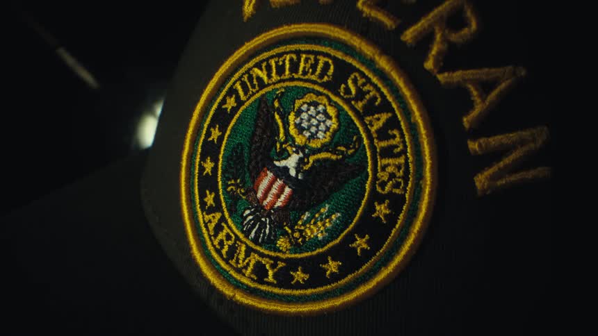 A view of a hat with a veteran patch on it