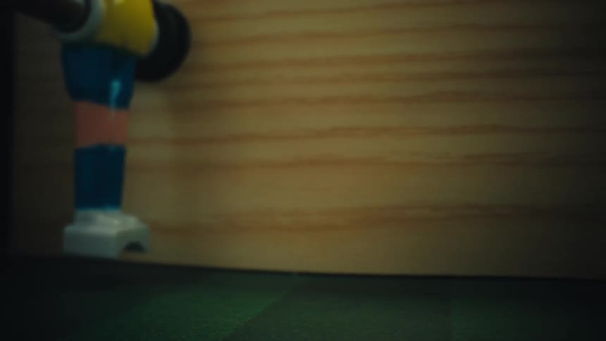 A soccer ball moving back and forth on a foosball table