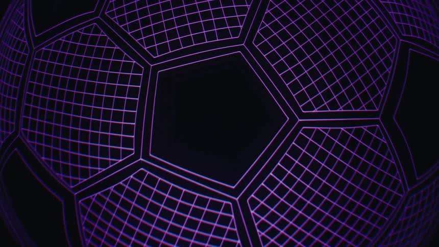 A close view of a glowing lamp shaped like a soccer ball with a grid pattern that changes between purple blue orange and green lights against a black background