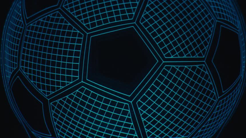 A glowing wireframe soccer ball lamp transitions through various colors against a dark background