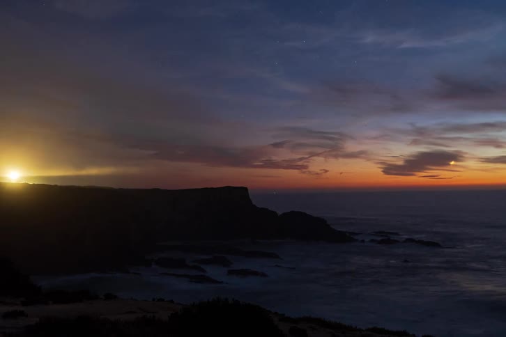 A time lapse of the sun setting over the coast