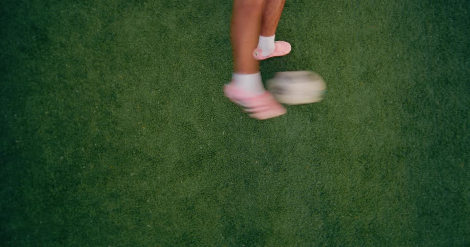 Soccer ball bounces on the field and a player kicks it away