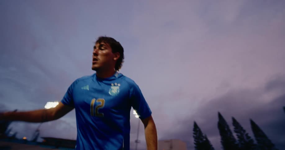 Player wearing a blue jersey moving during a game on a sports field