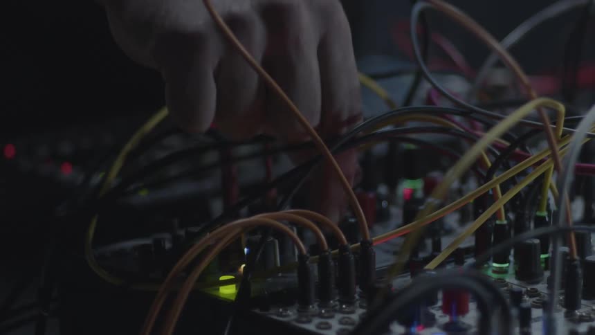 Hand adjusting cables connected to electronic audio equipment with multiple connectors