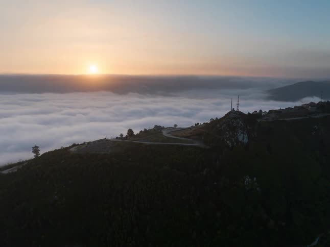An aerial view of mountains above clouds