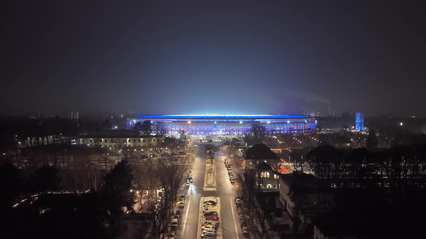 An aerial view of a city with a stadium in it
