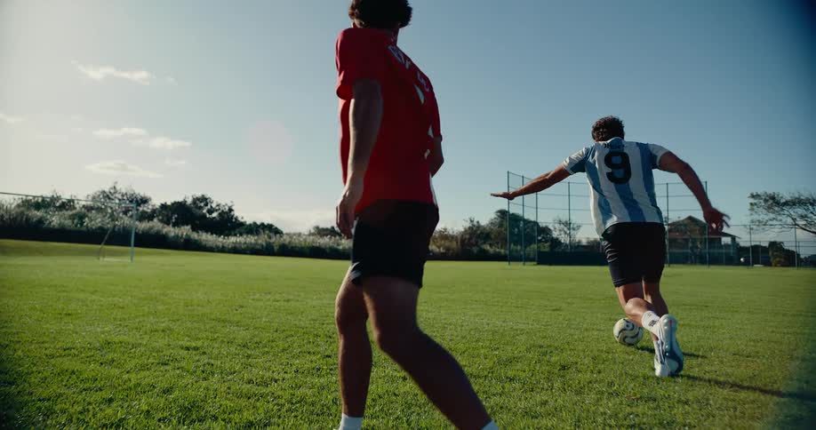 Soccer player uses fancy footwork and a trick move to get the ball past his opponent