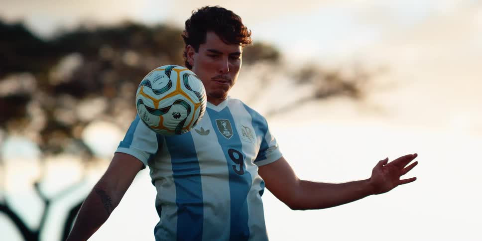 A man blocking a soccer ball with his body