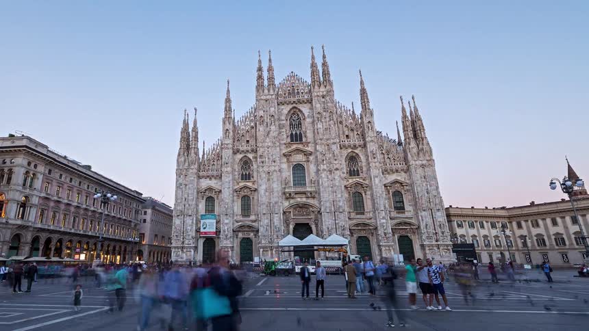 Large crowd of people walking outside of milan cathedral and the streets of neighboring buildings