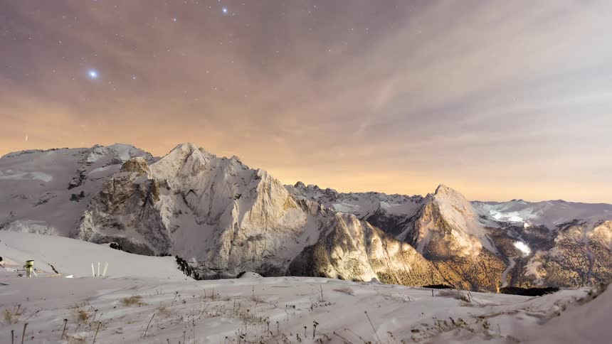 Snowy mountain landscape at starry dawn