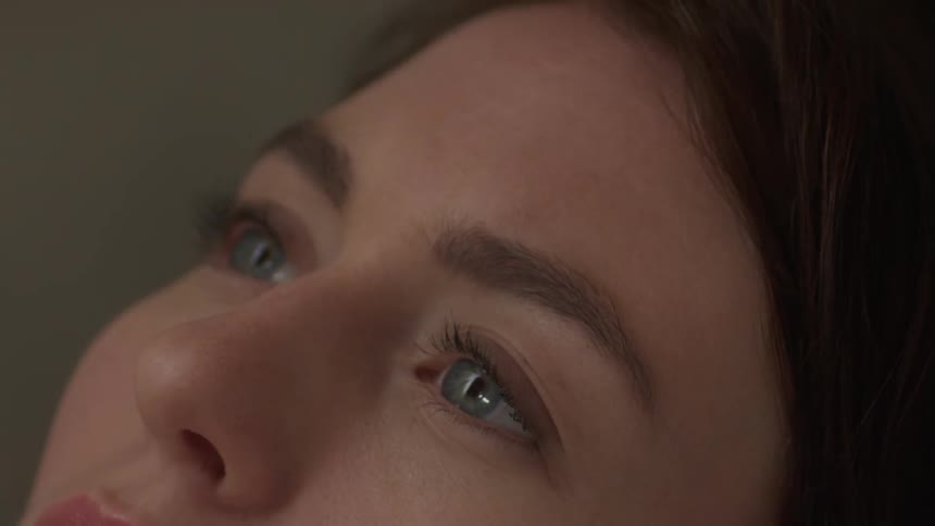 A woman leans her head back into water