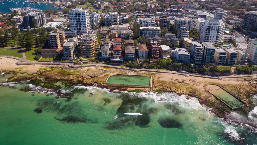 A time lapse of waves on a beach in a city