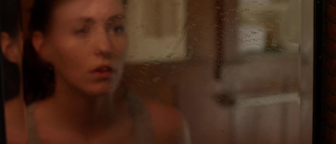 Woman stares into a mirror