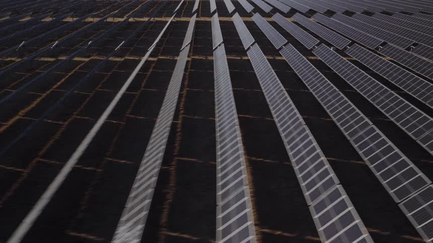 Solar panels on a solar farm lined up across the land