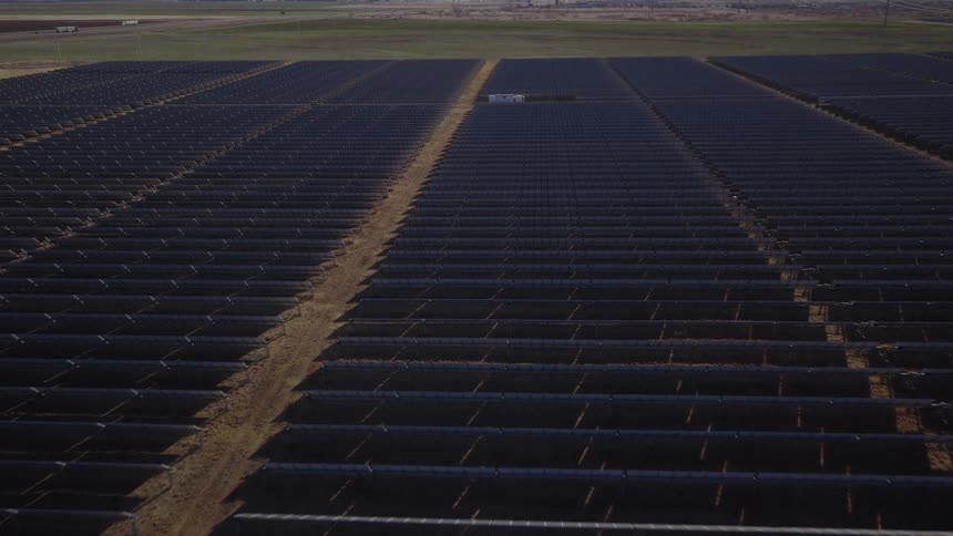 Building inside rows of solar panels on a solar farm