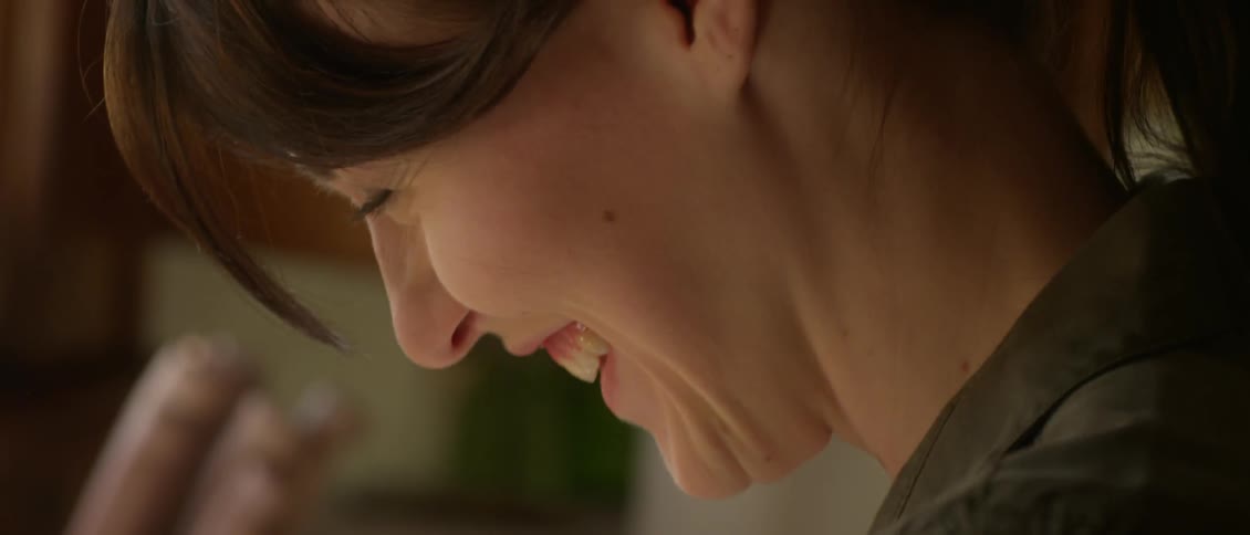 A woman smiles as she works