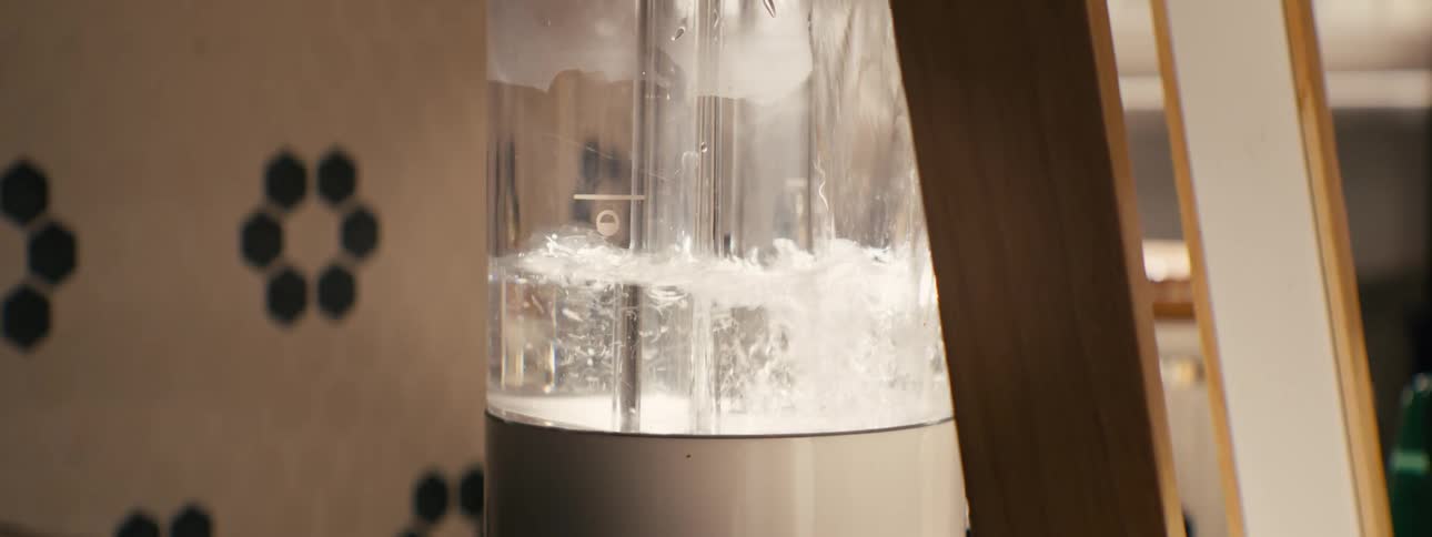 Water being poured into a modern coffee maker