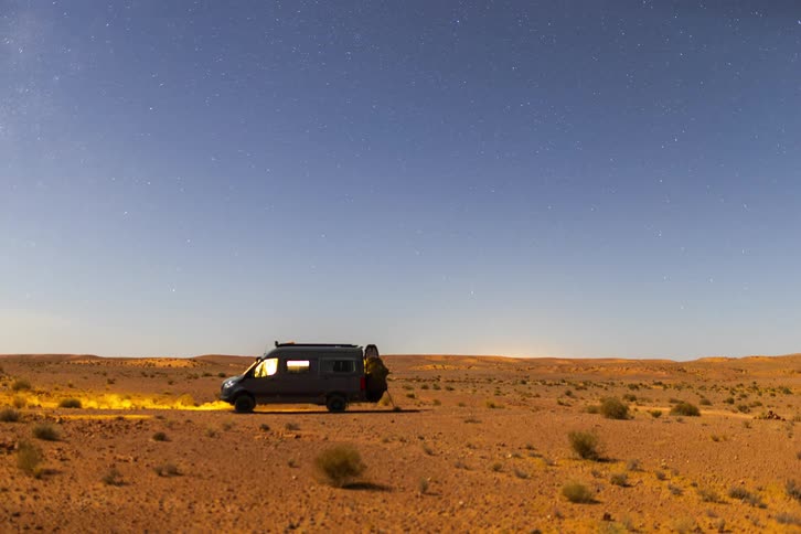 A van parked outdoors in the desert