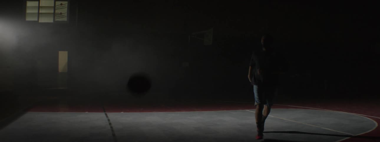 Man shoots basketball then walks off basketball court