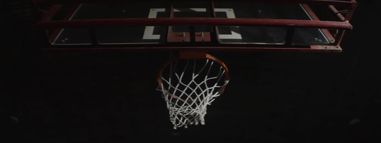 Basketball going into basketball hoop